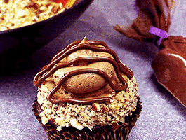 Chocolate cupcakes with chocolate icing or frosting with a piece of... 